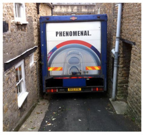 A lorry driver became a laughing stock after he followed his sat nav down a narrow country lane – and got wedged between two buildings.
